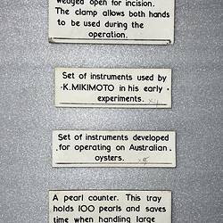 Four white labels of varying sizes with black text.