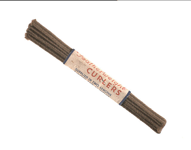Packet of straight curlers bound by paper.