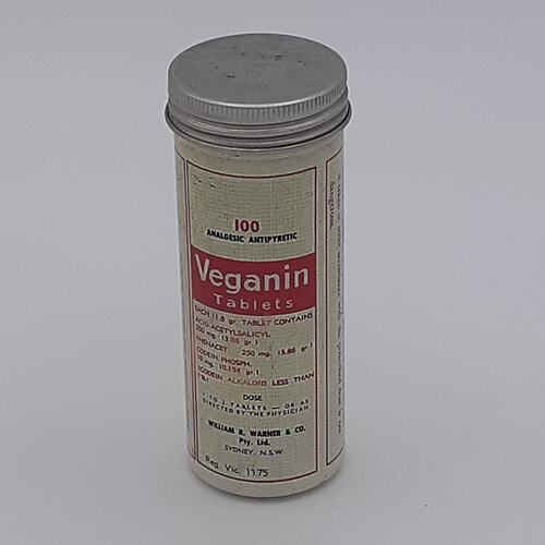 Metal cylinder with lid and white and red paper label adhered to front