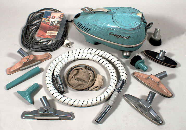 Vacuum cleaner with accessories around.