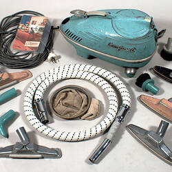 Vacuum cleaner with accessories around.