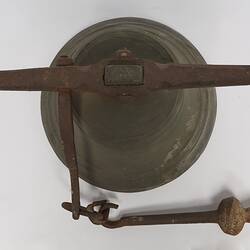 Metal bell, with a metal ringer for striking the bell. Top vew.