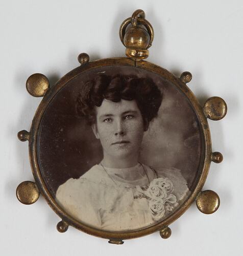 Pendant with photo showing woman's upper body.