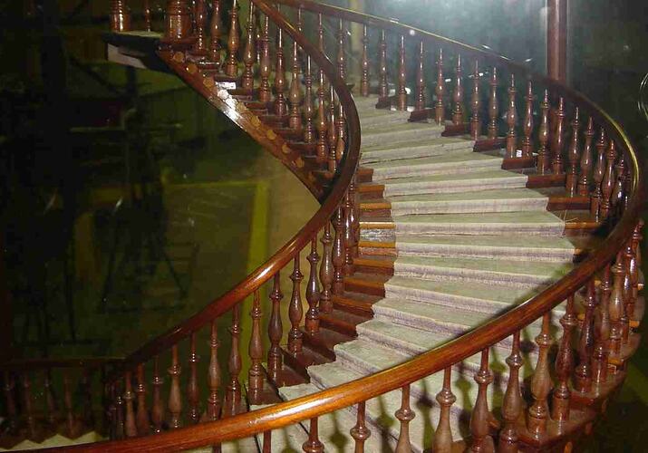 Model of a wooden staircase in a glass case.