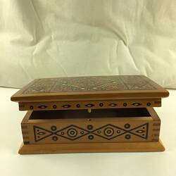 Timber inlay jewellery box. Geometric patterns in dark and light light brown, blue, yellow, white and red.
