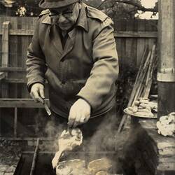 Digital Photograph - Man in Coat & Hat Cooking Chops on Barbecue, Caulfield, 1968