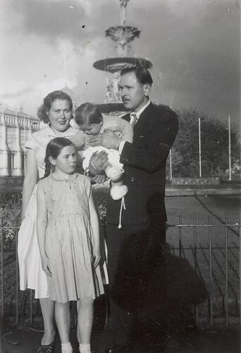 Digital Photograph - Two Girls, Mother & Father in front of Hochgurtel Fountain, Royal Exhibition Building, Carlton, 1957