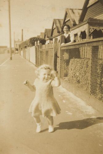 Digital Photograph - Infant Girl Toddling Down Street Watched by Mum, Croxton, 1944