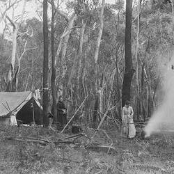 Black and white photograph of women in a bush camp.