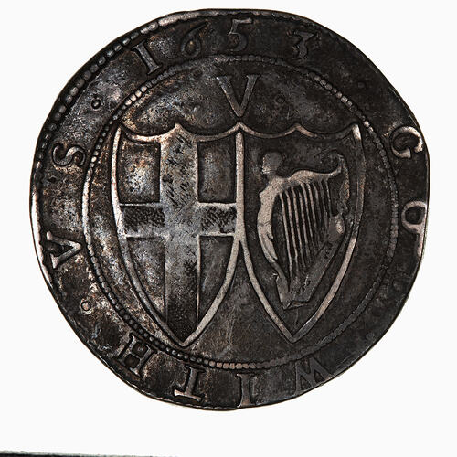 Coin, round, within a beaded circle two conjoined shields; one has St. George cross, the other the Irish harp.
