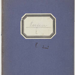 Blue note book with geometric label.