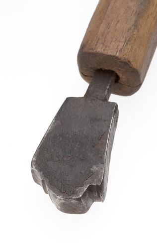 Front view iron tool mounted onto wooden handle.