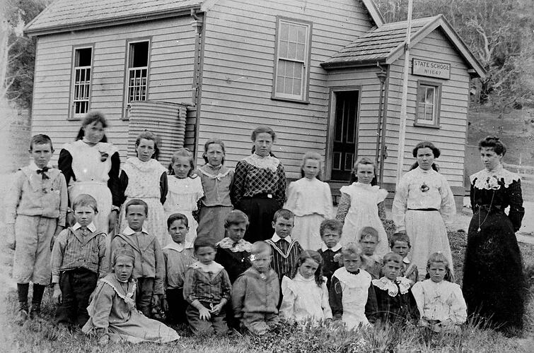 Children in front of weatherboard school.