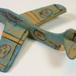 Multi-coloured wooden toy plane.