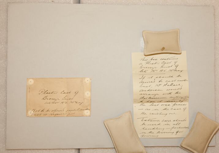 Handwritten letters held down with weighted bags.