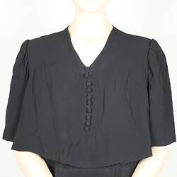 Top half of black dress, buttons on front.