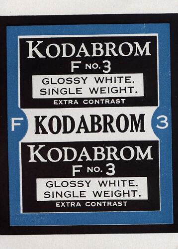 Black and white paper label with blue border.