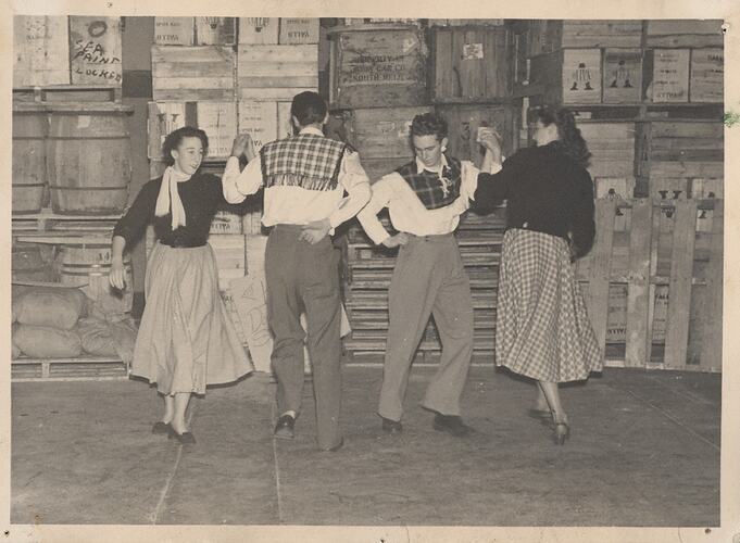 Two couples dancing in factory warehouse.