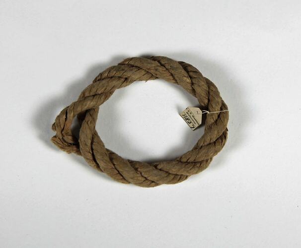 Coiled rope with label tied on one side.
