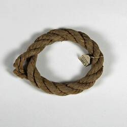 Coiled rope with label tied on one side.
