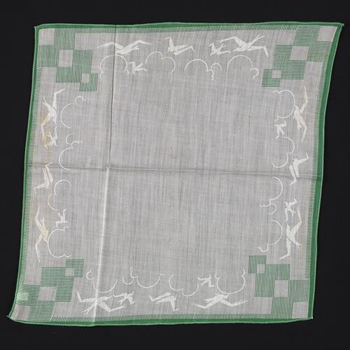 White handkerchief with green geometric pattern.