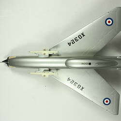 Silver model aeroplane. Blue, white and red rondels on wings and fuselage. Top view.