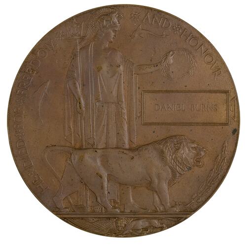 Bronze coloured medal with lion and woman holding trident and wreath.