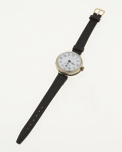 Watch, circular white dial, skeleton Arabic numerals, brown leather bands.