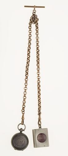 Silver watch chain with silver sovereign case and miniature book.