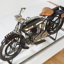 Green, cream motor cycle, top left view.