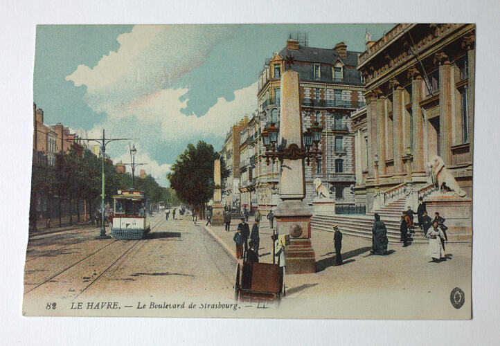 Streetscape with tram and pedestrians.