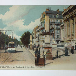 Streetscape with tram and pedestrians.