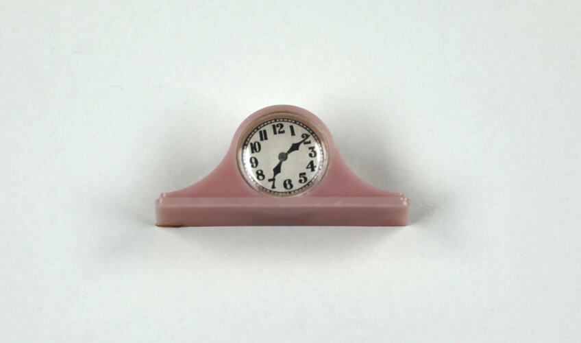 Pink toy mantel clock, front.