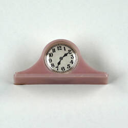 Pink toy mantel clock, front.