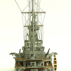 Naval ship with two masts, rear view.