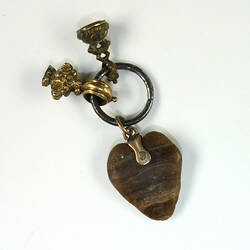 Heart-shaped charm with two smaller charms in velvet lined box.