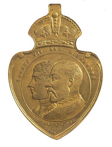 Shield shaped medal with crown atop featuring profile portraits of female and male.