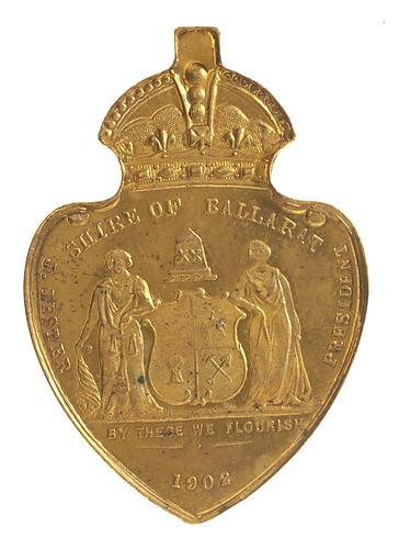 Heart shaped medal with crown atop. Features two figures supporting a shield. Text around.