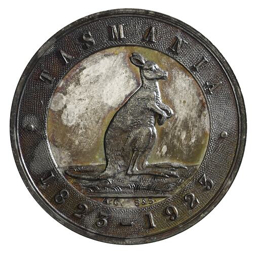 Round coin with raised text above and below a kangaroo.