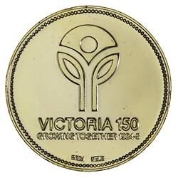 Round medal with logo of two single leaf stems supporting central inverted triangle. Text below.