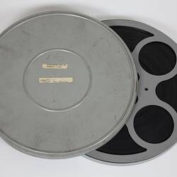 Round metal film canister. Open.