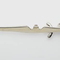Long thin section of metal forceps.