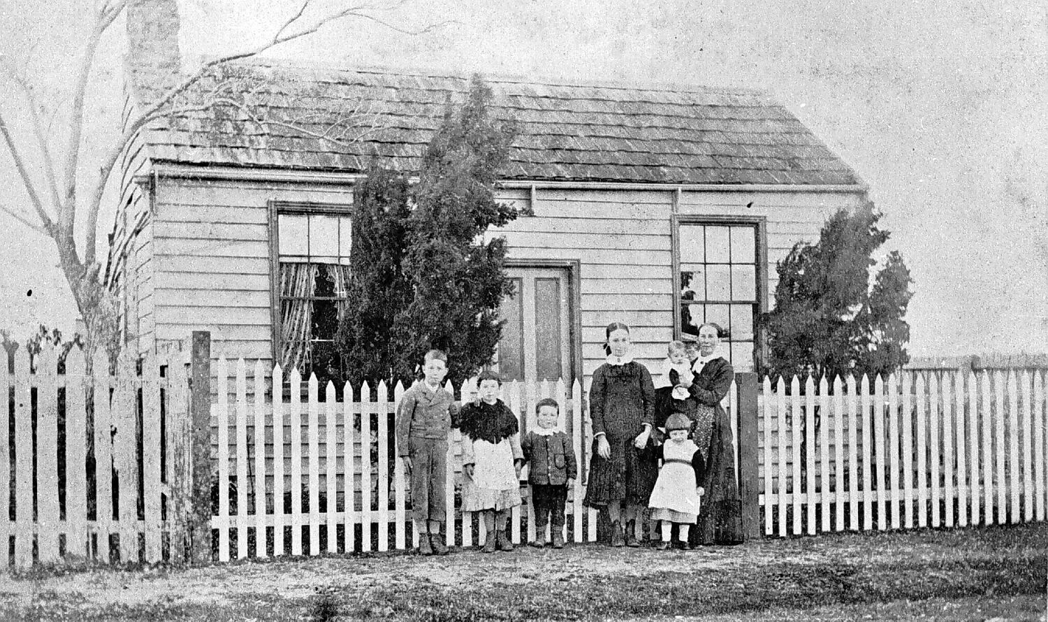 negative-family-group-standing-in-front-of-a-house-western-australia