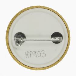 Back of round white badge.