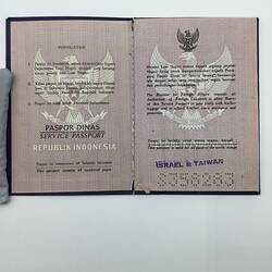 Open passport with white pages. Black printing. Garuda logo.