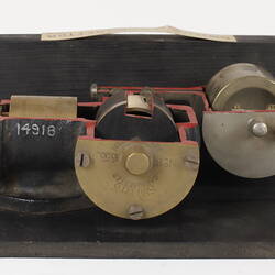 Sectioned Smith's carburettor on black stand. Top view.