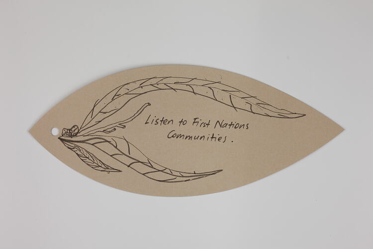 Pink paper leaf with handwritten text and illustration in black ink.