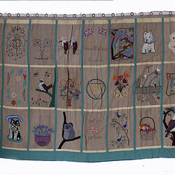 Front of curtains with extensive embroidery.
