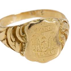 Gold ring with engraved shield design. Features Coat of Arms.