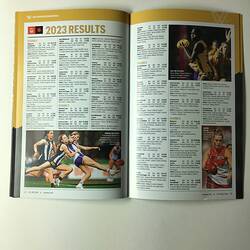 Open football record with text and female footballers on left page. Text and female footballers on right.